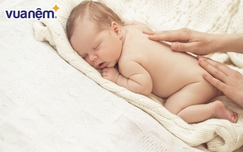 Quấn khăn nằm sấp tạo cảm giác an toàn, dễ chịu cho bé